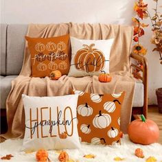 pumpkin pillows on a couch with fall decorations