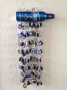 a bottle opener hanging from the side of a wall next to a blue toothbrush