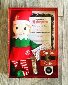 a red box with an elf doll and other items