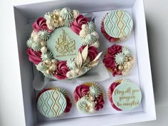 cupcakes in a white box decorated with red and gold decorations