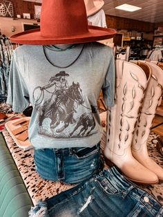 Fits true to size and is a unisex fit 50% Cotton 50% Polyester Model wears a small and is a size 4/6 and 5’8” Recommended Sizing: Small- 2/4/6 Medium- 8/10 Large- 12/14 XL - 16 Fitted Graphic Print T-shirt For Rodeo, Fitted Crew Neck T-shirt For Rodeo, Western Style Screen Print Tops For Summer, Fitted Western Style T-shirt For Summer, Graphic Print T-shirt For Rodeo, Western Style Screen Print Crew Neck Top, Fitted T-shirt For Rodeo In Fall, Western Crew Neck Top With Screen Print, Fitted Crew Neck Top For Rodeo