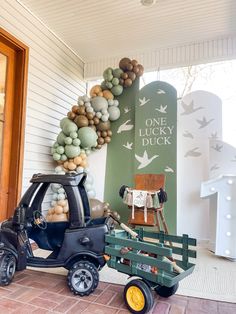 a car is parked in front of a sign that says one lucky luck with balloons on it