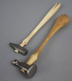 two wooden handled kitchen utensils on a gray surface