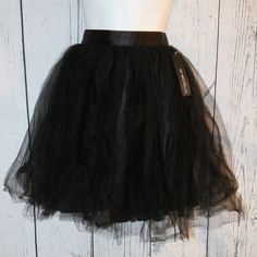 My Michelle Black Tulle Skirt In A Juniors Size Medium. New With Tags, This Has 2 Layers Of Tulle Over The Polyester Inner Liner. Has Zip Back Closure. This Is A Hand Wash Item. Flat Measurements Are Approx. 13-13.5" Across Waist, 20" Waistband To End Of Tulle However This Is Very Full And That Made An Accurate Length Difficult To Get, I Judge This As Knee Length Or Just Above Depending On Body Shapes As Some People Have Longer Legs/Longer Torsos Etc. Great New Condition. Cute For Dances/Dates Black Skirt For Spring Costume Party, Black Full Skirt Petticoat For Party, Black Skirt For Costume Party In Spring, Black Full Mini Skirt For Party, Spring Black Full Skirt Petticoat, Black Full Skirt Petticoat For Spring, Black Summer Petticoat For Costume Party, Black Tiered Skirt Petticoat For Party, Black Tiered Petticoat For Party