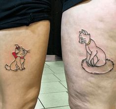 two people with tattoos on their legs, one has a cat and the other has a dog