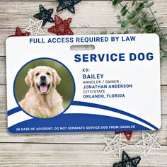 a service dog id badge on a wooden surface with stars and flowers in the background