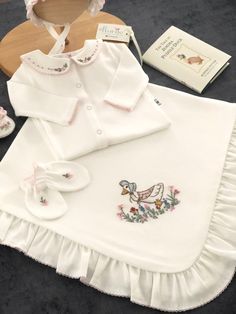 Announce your little baby's arrival with this special coming home outfit set.  This gorgeous set is completely hand embroidered by women using the Brazilian embroidery technique. You can keep this high quality set as a lifetime keepsake. You can also gift this set to your loved ones as a very special gift ⭐ Hand Embroidered Coming Home Outfit  Set is made of 100% Gots Certified Cotton Fabric. ⭐ Soft, stretchy cotton fabric that is breathable. ⭐ It will be sent in a special linen pouch. ⭐ 0-3 month 4 pieces set includes; 1- Blanket with ruffle 2- Sleepsuit 3- Hat 4-Mittens FAQs ⭐Care İnstructions *Gentle wash cool water in washing machine *Use cold water with mild detergent *Hang to dry *Dont use tumble dry  *Do not use bleach ⭐Custom and personalized orders We will quickly complete your or Cute White Sets With Floral Embroidery, White Cotton Sets With Machine Embroidery, New Born Clothes, Cute Embroidered Cotton Sets, Cute White Floral Embroidered Sets, White Cotton Sets With Embroidered Hem, Cute White Floral Embroidery Sets, White Embroidered Gift Sets, Nursery Embroidery