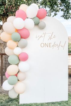 a large sign with balloons attached to it