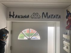 the front door to hakona matata is decorated with an image of mario and luigi