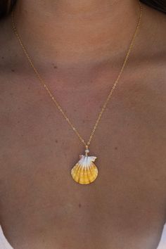 Bright yellow colored sunrise shell,wrapped in 14k gold filled wire. Accented with  a tiny moonstone gemstone and hung on a 18" gold filled chain. Shell is quarter size, found on Oahu. 14k Gold Filled Shell Shaped Jewelry Gift, Yellow Gold Shell Jewelry For Gifts, Gift Yellow Gold Shell Jewelry, Yellow Gold Shell Jewelry Gift, Gold Wire Wrapped Necklace For The Beach, Ocean-inspired Gold Wire Wrapped Jewelry, Gold Wire Wrapped Shell Necklace, Gold Wire-wrapped Necklaces For The Beach, Handmade Shell-shaped Yellow Gold Jewelry