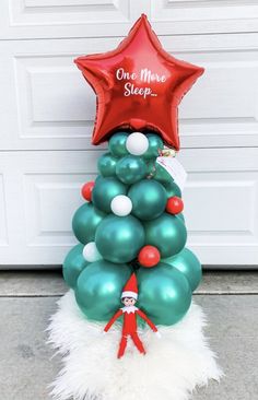 a christmas tree made out of balloons with a star on top and one more sleep