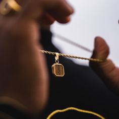 The Tigers Eye Pendant. Created using real cuts of a Tigers Eye Gemstone. Every stone is unique making it the perfect necklace for your unique style.  Also available in Silver. DETAILS Pendant size: 1.5cm x 1.5cm  Chain styles: Rope (2.5mm) Materials: Stainless Steel / 18K Gold PVD Plating Necklace clasp: Lobster Packed in a Twistedpendant Jewellery Pouch Hypoallergenic Tigers Eye Gemstone SIZING This chain is available in lengths: 20", 50.8cm  22", 55.8cm  24" 61cm  Model is wearing 22"  If not