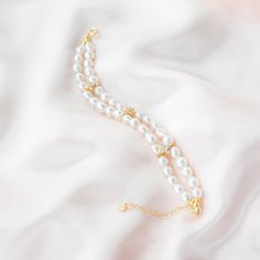 This Baroque bracelet features two layers of delicate chain adorned with sparkling four-leaf clover zircon pieces. The unique Baroque design adds a touch of vintage elegance, while the zircon accents add a touch of sparkle. Perfect for dressing up any outfit like wedding dresses or adding a touch of elegance to your everyday look. This bracelet is a must-have for any pearl jewelry lover. Pearl Type: Freshwater Baroque Pearls Pearl Quality: [Shape]: Baroque Irregular Shape [Pearl Size]: 6-7mm [Bl Elegant Double Strand Gold Plated Jewelry, Elegant Gold Plated Chain Bracelet With Diamond Accents, Elegant Chain Bracelet With Diamond Accents For Wedding, Elegant Sparkling Stones Chain Bracelet As Gift, Elegant Diamond Accents Chain Bracelet For Wedding, Elegant Double Strand Jubilee Bracelet, Elegant Chain Bracelet With Sparkling Stones As Gift, Elegant Cubic Zirconia Chain Bracelet, Elegant Formal Crystal Bracelet With Adjustable Chain