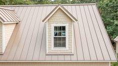 a house with a metal roof and two windows