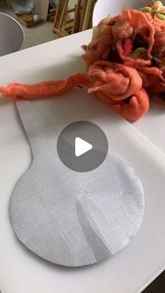 a video demonstrating how to cut fabric on a cutting board with scissors and yarn in the background