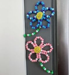 the door is decorated with colorful beads and flowers on it's side, as well as a magnet