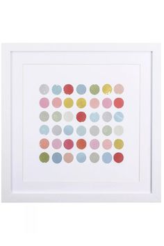 a white framed art print with multicolored polka dots