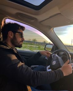 a man sitting in the driver's seat of a car