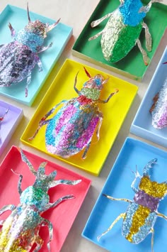 colorful paper plates with different types of bugs on them, all made out of glitter