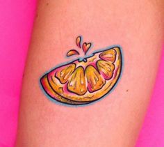 an orange slice tattoo on the right thigh