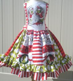 a dress made out of red and white striped fabric with green polka dots on it