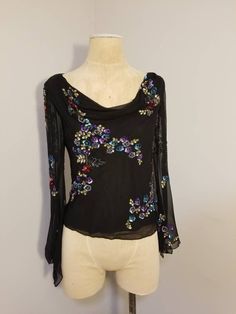 "++ NEWPORT NEWS SILK BLOUSE ++ Gorgeous sequin and beaded top Colorful floral design of sequins Draped neckline See through/sheer bell sleeves Snaps on the interior to hold your bra strap up Fully lined except for the sleeves 100% Silk  Size 12 Made in India In excellent vintage condition -  the interior lining has been sew a bit at the back - no rips or tears I just think it probably stuck out a little but under the silk -  ✂ - - - Measurements laid flat: Pit to pit: 20\" Waist: 17.5\" Hips: 1 Glamorous Embroidered Tops For Evening, Glamorous Embroidered Evening Tops, Embellished Long Sleeve Wedding Top, Long Sleeve Embellished Wedding Tops, Elegant Long Sleeve Blouse With Sequins, Elegant Long Sleeve Sequined Blouse Piece, Elegant Long Sleeve Sequin Blouse, Multicolor Sequined Blouse For Wedding, Elegant Multicolor Tops With Floral Embroidery