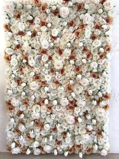 a white and brown flowered wall hanging on the side of a building with flowers all over it