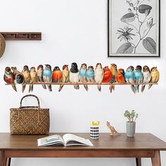 a group of birds sitting on top of a wooden shelf