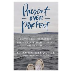 a book cover with the title present over perfect, featuring an image of a person's feet in water