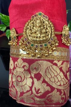 Aravanki Goddess Lakshmi Aravanki ONE/Antique Gold Finish/Gold Beads Drop Size12.4Inches around up to16 inches total/Adult Armlet/Adjustable This item is perfect for any occasion, from party wear to casual wear! It is traditional and trendy at the same time. DETAILS: Includes One Armlet/arm Band, Around 12 inches aravanki  Size: _12.4 inches total 16 inches to go up Arm Round _ See images for details. Weight: 2.45oz (69g) Material: Imitation Gold. Red and green kemp. Finish: Premium Antique gold finish.  NOTE: We try our best to show you photos of our items as they appear in real life, but please note that variations in color occur due to differences in lighting and screen settings.  PRODUCT CARE: - Avoid contact with heat/fire, water, and chemicals such as perfumes or any sprays to preven Temple Necklace With Zari Work For Ceremonial Occasions, Ceremonial Temple Necklace With Zari Work, Adjustable Traditional Temple Necklace, Gold Saree With Temple Jewelry For Traditional Ceremonies, Festive Gold Saree With Latkans, Gold Saree For Traditional Ceremonies, Traditional Red Saree With Latkans, Temple Jewelry Style Saree With Tilla For Festive Occasions, Gold Temple Jewelry Traditional Wear For Ceremonies