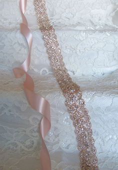 "Stunning rose gold crystal rhinestone sash. Extreme sparkle! Securely fastened onto a quality double faced satin ribbon which ties into a bow and drapes down the back of your wedding dress. Perfect finishing touch for your wedding attire! Please make your choice of rhinestone trim length, ribbon colour, no ribbon or hook and eye closure from the drop down menus. Contact me if you have a custom length requirement. Ribbon options to purchase: You may purchase just the rhinestone trim ( no ribbon Rose Gold Bridal Accessories, Bridal Accessories Earrings, Wedding Dresses Blush, Wedding Dress Belt, Bridal Accessories Jewelry, Rose Gold Crystal, Wedding Sash