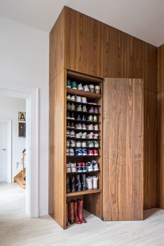 a wooden cabinet filled with lots of shoes