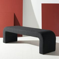 a black bench sitting in front of two red and white walls