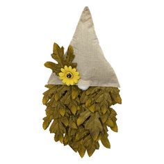 a gnome's hat made out of leaves with a yellow flower on it and a white background