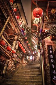 an alleyway with lanterns and signs on the steps leading up to buildings in chinatown, hong kong