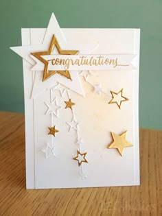 a congratulations card with gold stars on it