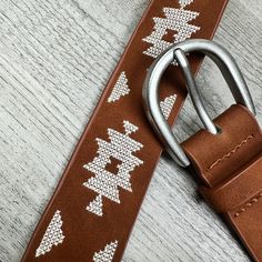 Elevate your look with our expertly crafted Tribal Embroidered Belt. Made with precision and quality, this belt will add a touch of sophistication to any outfit. One Size Length 42" Approximately Width 1.5" Metal Buckle Embroidered details Embroidered Belt, Flannel Jacket, Woven Belt, Graphic Tops, Romper With Skirt, Metal Buckles, Dress Accessories, Set Dress, Camel