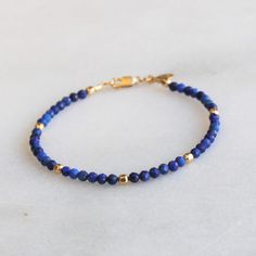 Gorgeous natural lapis is hand strung to create this beaded bracelet.  It's accented with 14kt gold filled touches.  Lapis is know as the friendship stone! D E T A I L S *Hand strung genuine natural lapis *14kt gold filled accent beads  *Fits up to a 6.5 inch wrist, optional extender available ∙ EXTRA LOVE ∙ Handcrafted just for you in sunny Arizona by a team of talented women. All of our jewelry comes gift packaged! We are happy to leave a note if this is a special gift, just let us know in the message box at checkout. PRODUCTION ∙ TIMES All items are made to order. Please check the estimated delivery in the shipping section for the most current production time. If you need it sooner, select a faster shipping at checkout. All designs & content © The Silver Wren Double Chain Bracelet, Lapis Jewelry, The Friendship, Bracelet Dainty, Handmade Jewelry Gift, Message Box, Bracelets For Women, Bead Jewelry, Bracelet Handmade