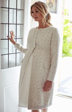 Our chic, collarless Verity coat exudes easy style. Tailored for the perfect fit with bust darts and pleated back panels, the Verity looks stylish whatever the occasion. Full-length sleeves give you extra cover and warmth in a luxurious woven cream bouclé fabric, flecked with blue, pink and silver flecks to introduce subtle sparkle to any day or evening look. Faux pockets are piped at the seam for attention to detail with concealed front fastening to flatter your bump. •Collarless style •Piped f Maternity Casual Dresses Winter, Winter Casual Maternity Dresses, White Pregnancy Dress Winter, Nursing Dress For Wedding Tiffany Rose Maternity, Pregnancy Dresses Fall, Maternity Wedding Dresses Formal, Maternity Dresses Business Casual, Maternity Evening Dress Tiffany Rose Maternity, Formal Winter Maternity Dress