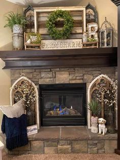 a fireplace with some plants and other decorations on it's mantel above the fire place