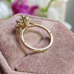 a gold ring sitting on top of a pink blanket