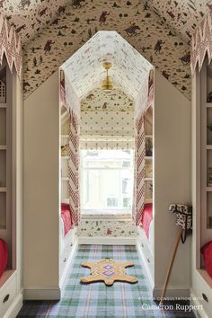 a room with two bunk beds and a rug on the floor in front of it