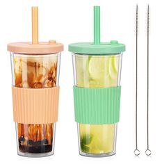 two cups with lids and straws next to each other, one filled with drinks