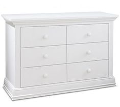 a white dresser with four drawers and two knobs on the top, in front of a white background