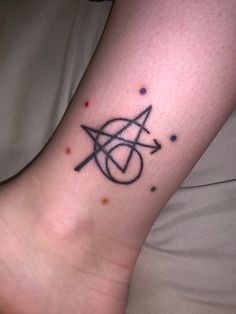 a person with a tattoo on their foot that has an arrow and star in it