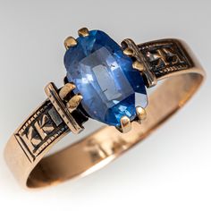 This beautiful circa late-Victorian ring contains one (1) cushion mixed cut natural sapphire weighing 1.92 carats and set into a four-split prong head. Engraved details accent the shoulders of the shank. The ring measures 10.2mm at the top, rises 4.0mm above the finger, tapering to 3.4mm wide and 0.6mm thick at the base of the shank. The ring is currently size 7.5 and has a nice aged patina. Sapphire Antique Ring, Antique Rings Victorian, Antique Gold Rings, Victorian Rings, Cabochon Ring, Aquamarine Jewelry, Unusual Jewelry, Sapphire Engagement, Natural Sapphire