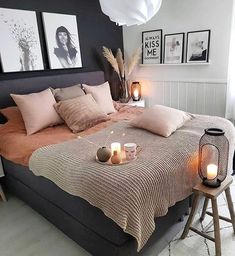 a bed with candles and pictures on the wall