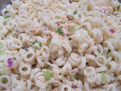 a bowl full of macaroni salad with onions and celery