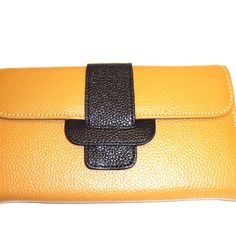 Hampton Gems-Two Tone Leather Wallet/Clutch. Very Soft Leather. Use This As A Clutch Or A Wallet To Put In A Bag. It Can Fit A Cell Phone. I Love It !!!! Ships In A Box, So Its A Perfect Gift. Perfect Summer Accessory. Available: Orange/Blue, Grey/Yellow, Black/Orange, Tan/Black Bag Depth: 1″ Inches Bag Length: 8″ Inches Bag Height: 4.5″ Inches Orange Pouch Wallet For Daily Use, Orange Leather Wallet For Daily Use, Orange Leather Bifold Wallet, Orange Clutch With Removable Pouch For Travel, Everyday Orange Leather Wallet, Orange Leather Wallets With Interior Card Slots, Orange Leather Wallet With Card Slots, Orange Travel Wallets With Interior Card Slots, Yellow Leather Rectangular Wallet