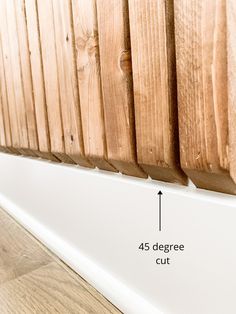 the side of a wooden slatted wall with measurements for wood planks on it